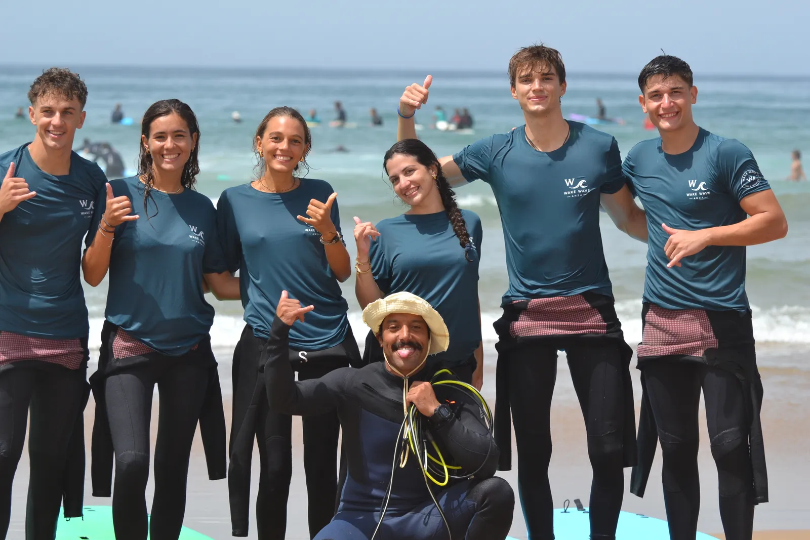 A group from the Wake Wave photo archive posing together on the beach.